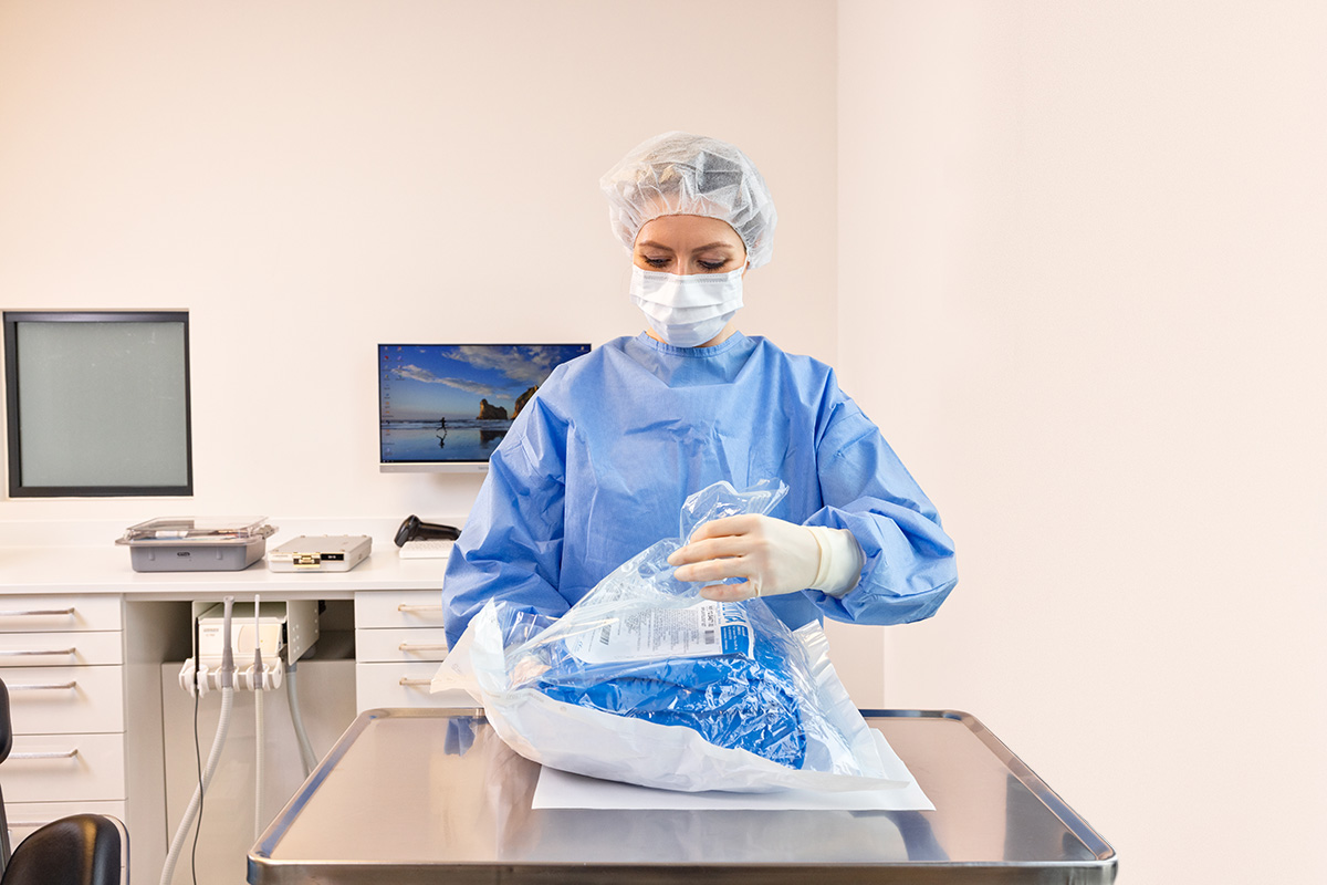 Clinician preparing a sterile procedural set